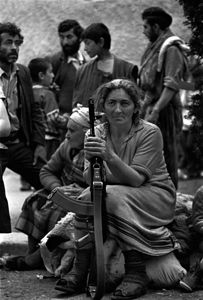 Armenian woman with family and Kalashnikov. Karabakh, Armenia, Soviet Union, (1991).
Photo by Oleg Klimov