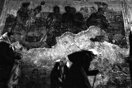 Orthodox believers in Svoboda (Freedom) village, Kursk region - holy place where was found the ikon "Korennaya" 700 years ago.
On the wall - the old frisco.
(Photo by Oleg Klimov/Pressphotos)