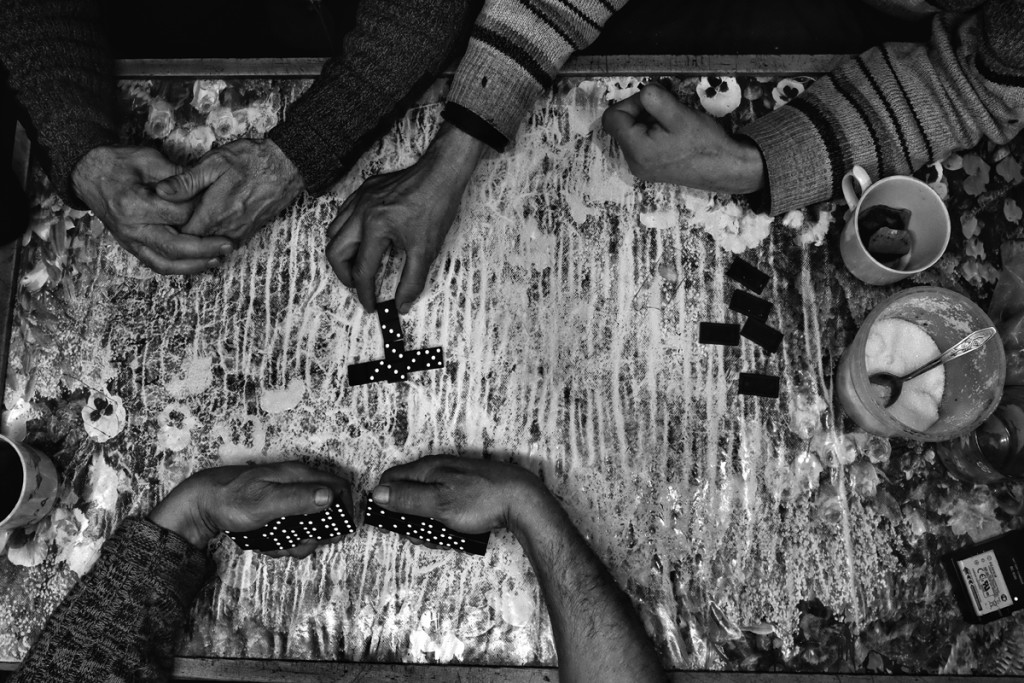 On breaks, as the boat travels to another fishing spot, fisherman sometimes play dominoes or cards. Fishing boat (Dorka) Number 49. Sakhalin region, the North Pacific.